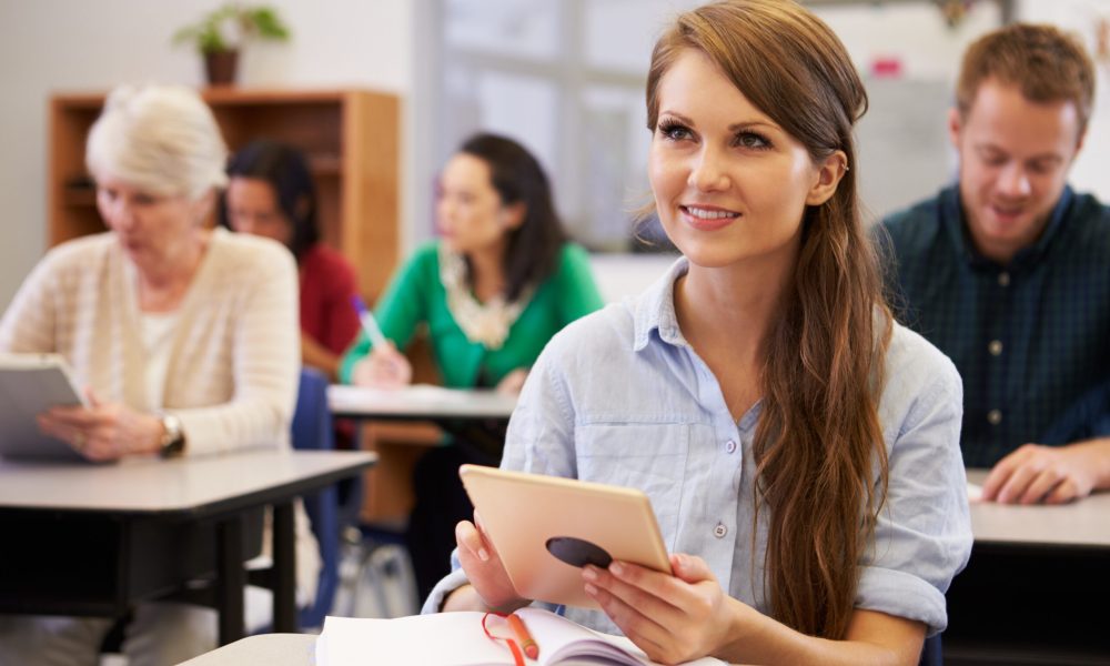 Young woman with tablet computer at an adult education class