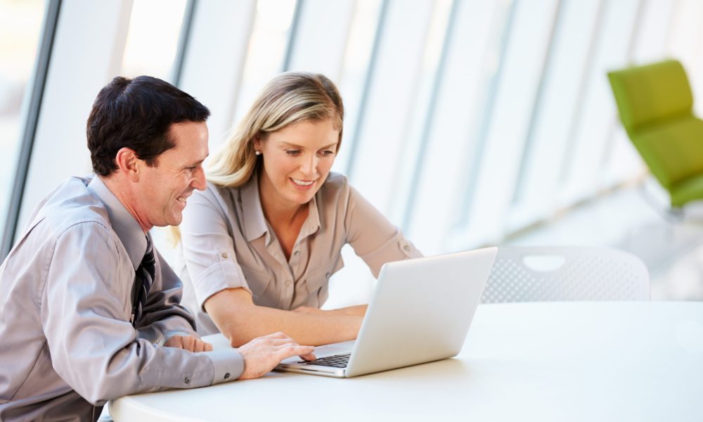 Business people Having Meeting Around Table In Modern Office